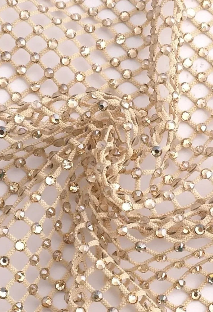 SlaySwimwear beige rhinestone mini skirt with clasp closure, above-the-knee length, and all-over sparkle.
