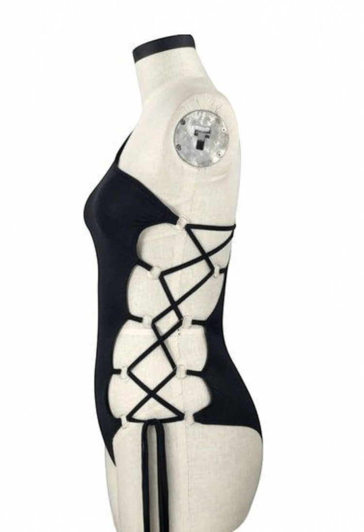 SlaySwimwear black one-piece swimsuit with lace-up side detail and halter neck. Celebrates unity and justice.