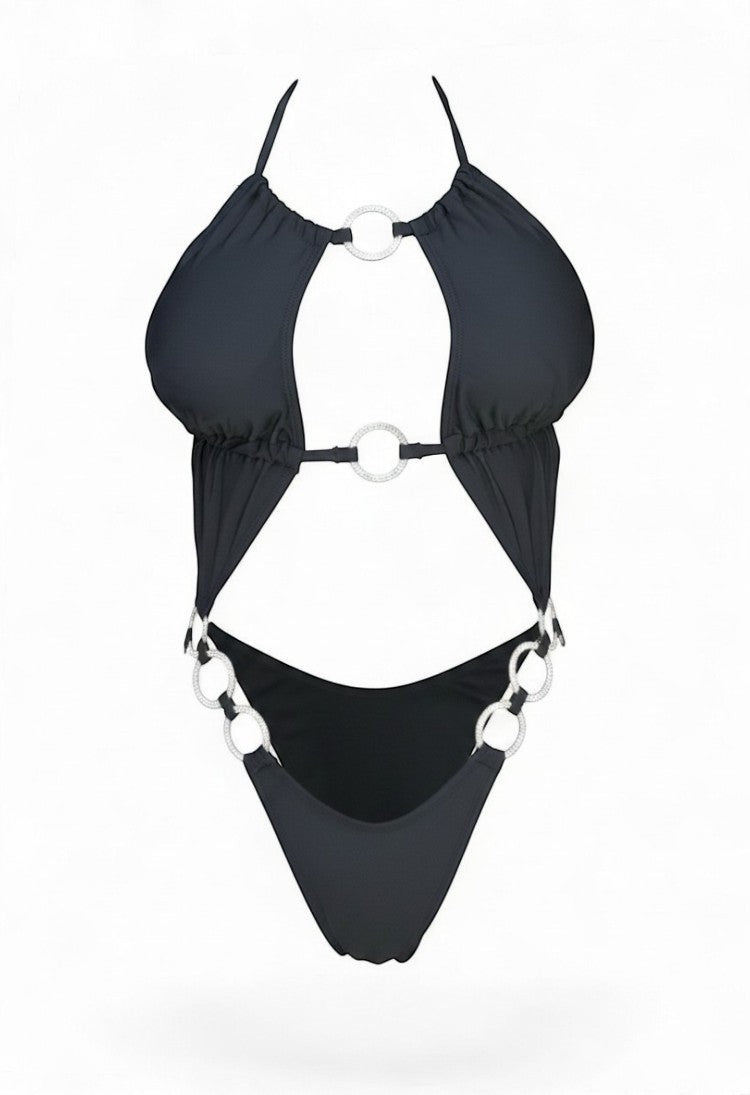 SlaySwimwear black one-piece swimsuit with adjustable straps adorned with rhinestone rings. Features a plunging neckline and high-cut legs.
