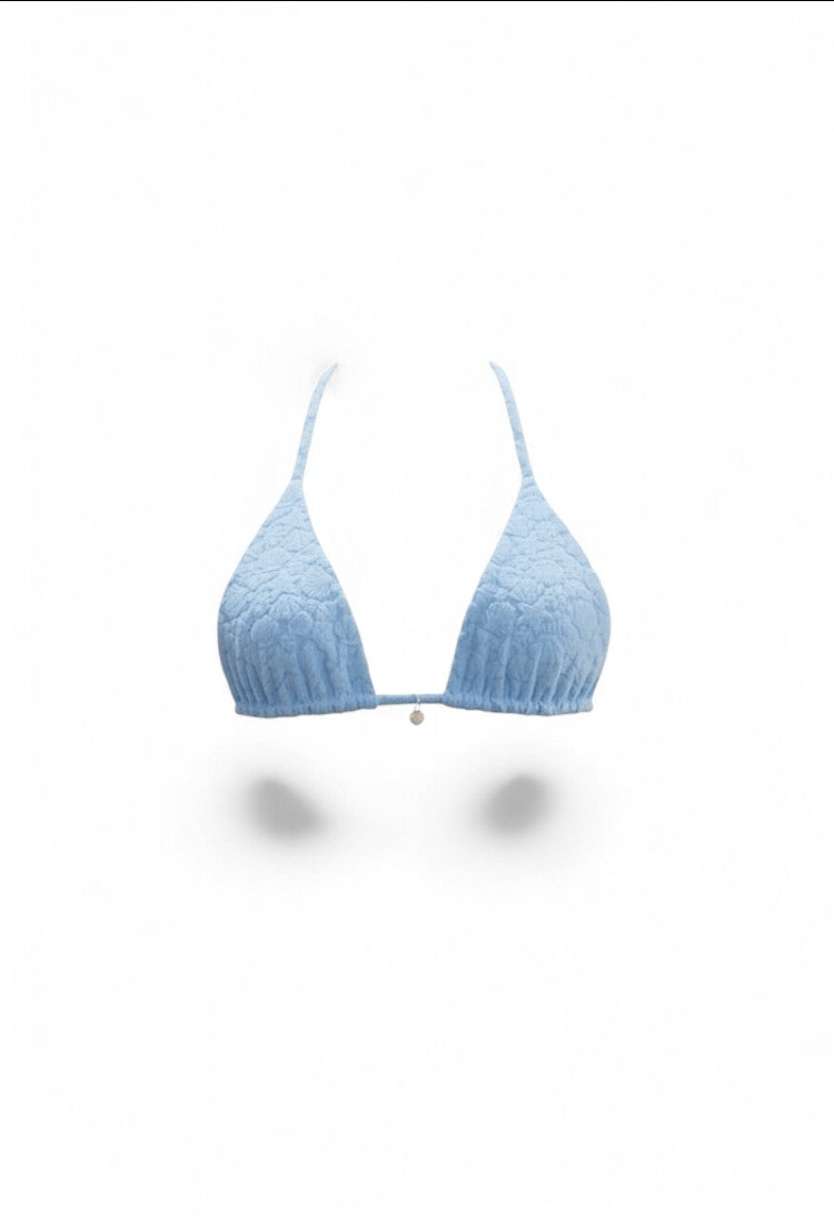 SlaySwimwear blue bikini with 3D shell-inspired fabric, adjustable ties, and gold charm accents.