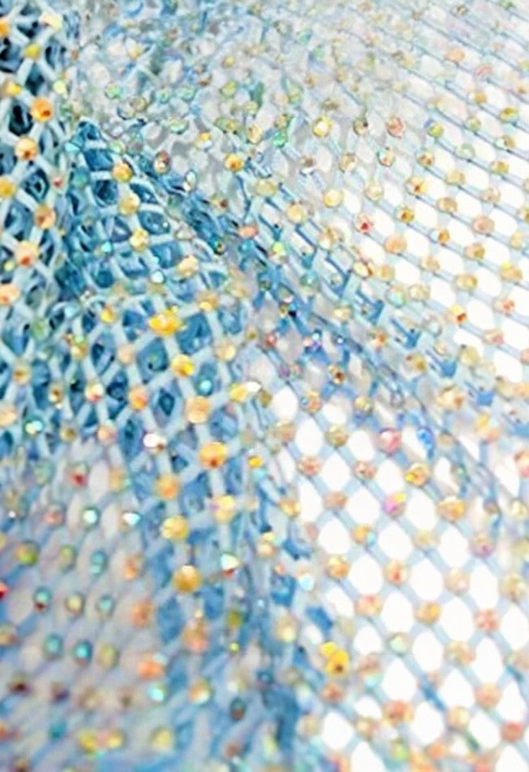 SlaySwimwear blue rhinestone mini skirt with clasp closure, above-the-knee length, and all-over sparkle.