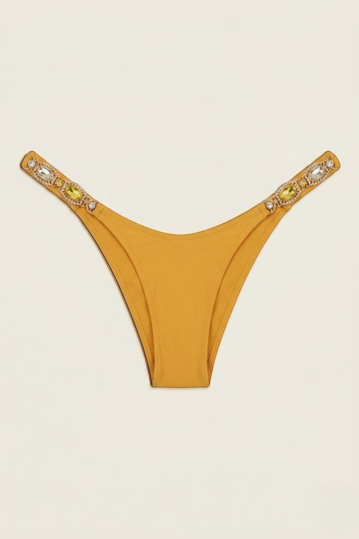 SlaySwimwear Golden Gem bikini bottoms in mustard yellow with jeweled straps on hips.