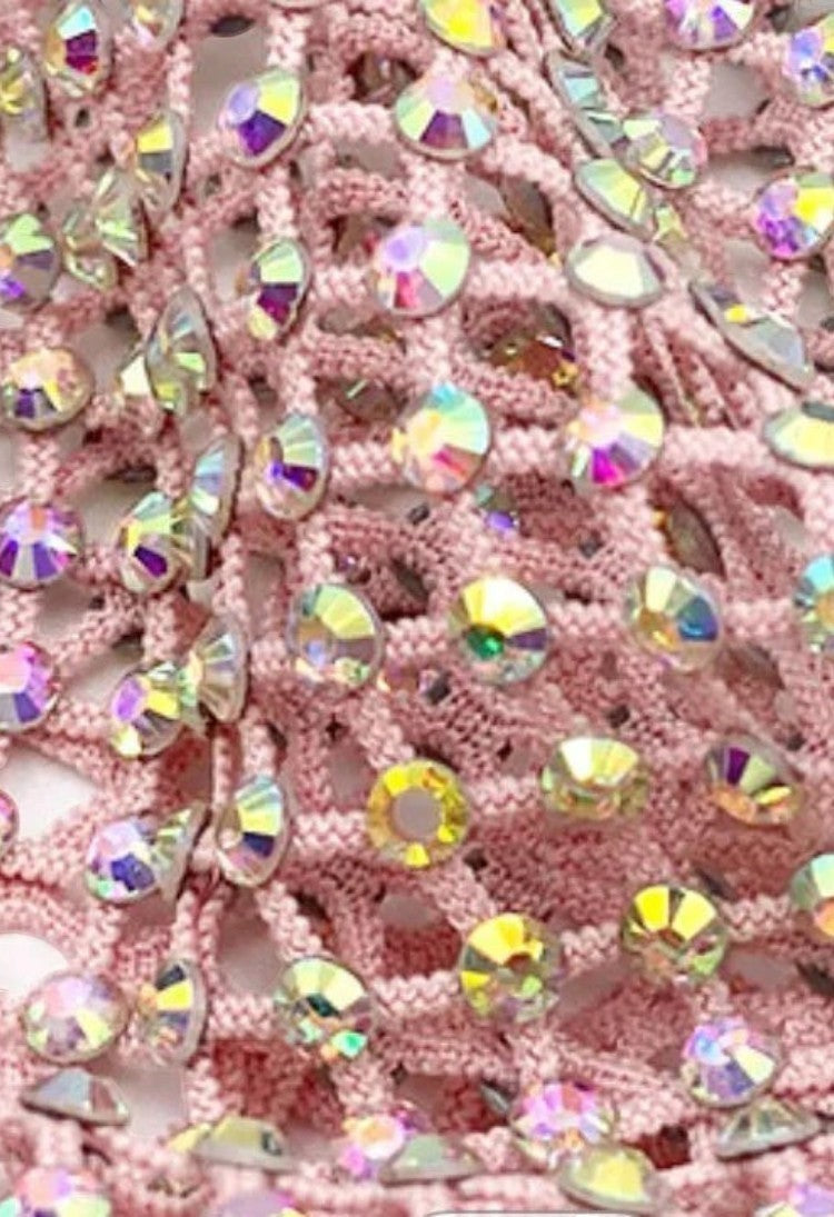 SlaySwimwear pink crochet mini skirt with all-over iridescent rhinestone embellishments and clasp closure.