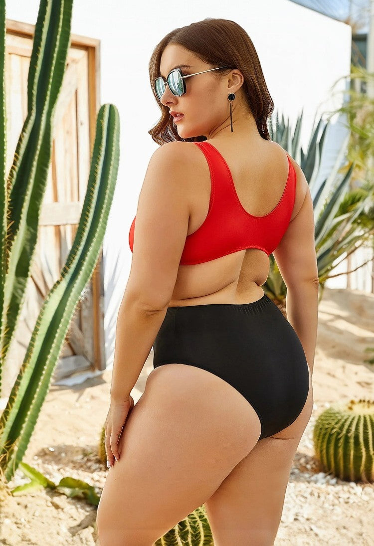 SlaySwimwear red and black color block one-piece swimsuit with high-waisted bottoms and cut-out detail on a curvy model.