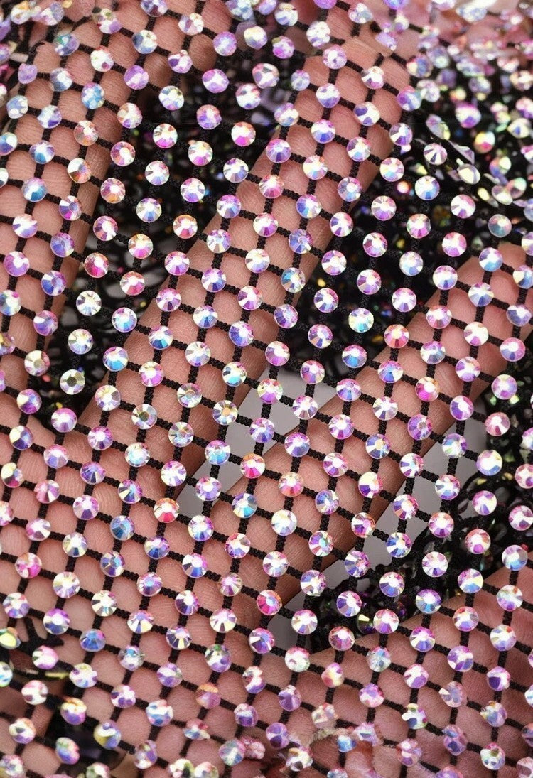 SlaySwimwear black mini skirt with all-over iridescent rhinestone embellishments and clasp closure.