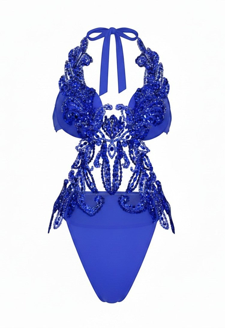 SlaySwimwear royal blue one piece swimsuit with plunge halter neck and ornate rhinestone & sequin applique. High-cut legs.