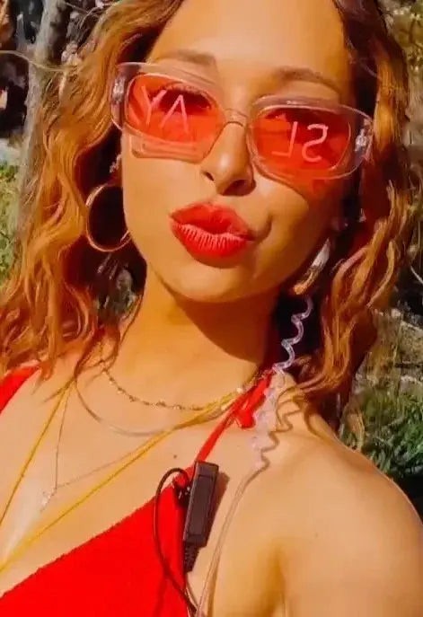 SlayEyewear Statement Sunglasses with translucent pink rectangular frames and red "SLAY" text on lenses.