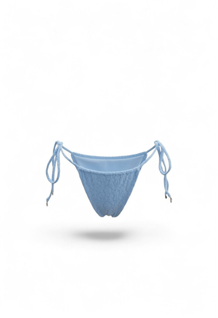 SlaySwimwear Beach Babe blue bikini with 3D shell-inspired fabric, adjustable ties, and gold charm accents.