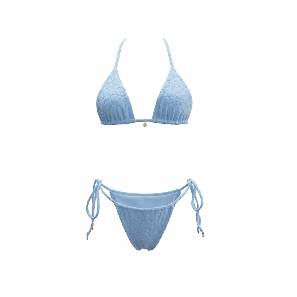 SlaySwimwear Beach Babe blue bikini with 3D shell print fabric, adjustable ties, and gold charm accents.