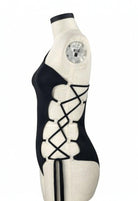 SlaySwimwear black one-piece swimsuit with lace-up side detail and halter neck. Celebrates unity and justice.