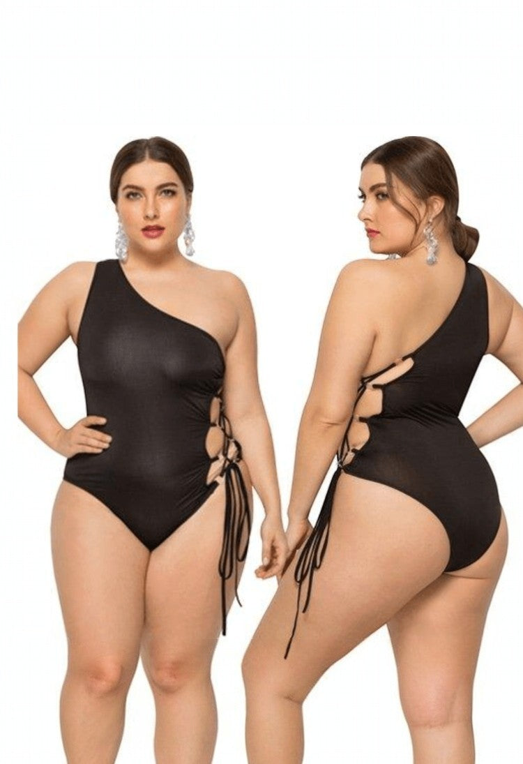 SlaySwimwear black one-shoulder swimsuit with lace-up sides and adjustable ties. Plus size.
