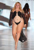 SlaySwimwear black monokini with O-ring cutouts and rhinestone accents, adjustable halter top, high-cut leg, and sheer black cover-up.