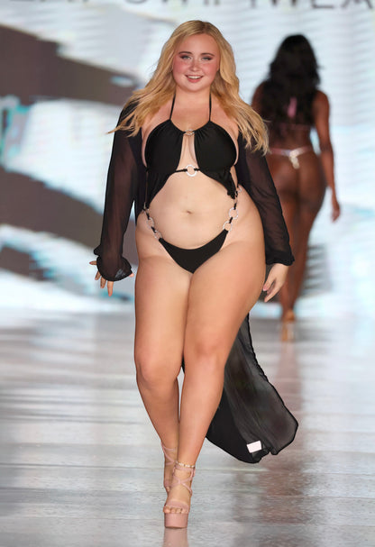 SlaySwimwear black monokini with O-ring cutouts and rhinestone accents, adjustable halter top, high-cut leg, and sheer black cover-up.