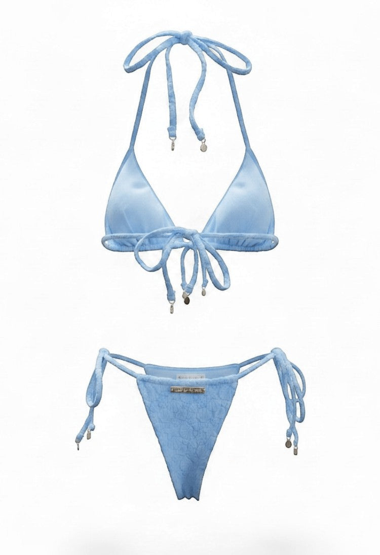SlaySwimwear blue bikini with 3D shell print fabric, adjustable ties, and gold charm accents. Beach Babe style.