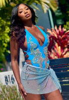 SlaySwimwear blue rhinestone mini skirt with clasp closure and mesh overlay, perfect for parties and nights out.