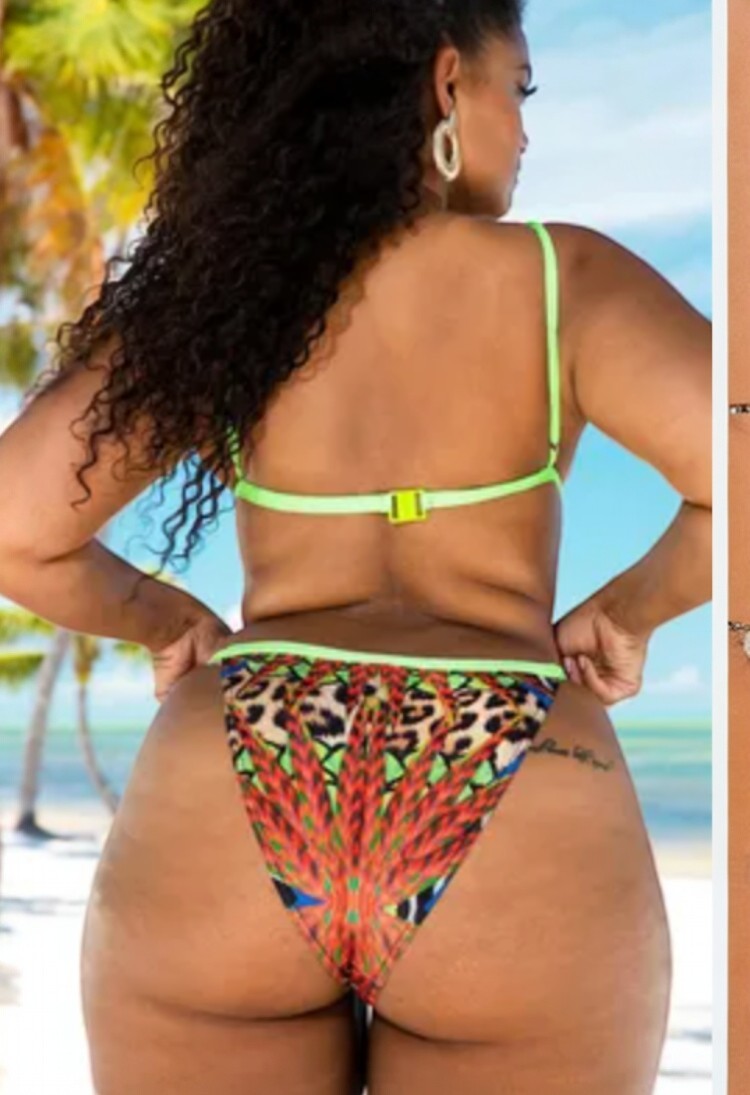 SlaySwimwear Lion Queen leopard print bikini with neon green trim and matching bottoms. Model wears large hoop earrings.