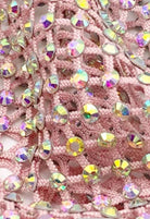 SlaySwimwear pink crochet mini skirt adorned with iridescent rhinestones and a rhinestone clasp closure.