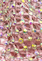 SlaySwimwear pink crochet mini skirt with all-over iridescent rhinestone embellishments and clasp closure.