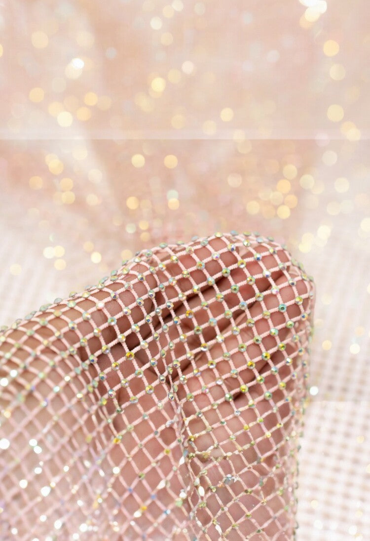SlaySwimwear pink rhinestone mini skirt with clasp closure, featuring all-over sparkle and above-the-knee length.