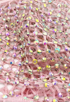 SlaySwimwear pink crochet mini skirt adorned with iridescent rhinestones and a rhinestone clasp closure.