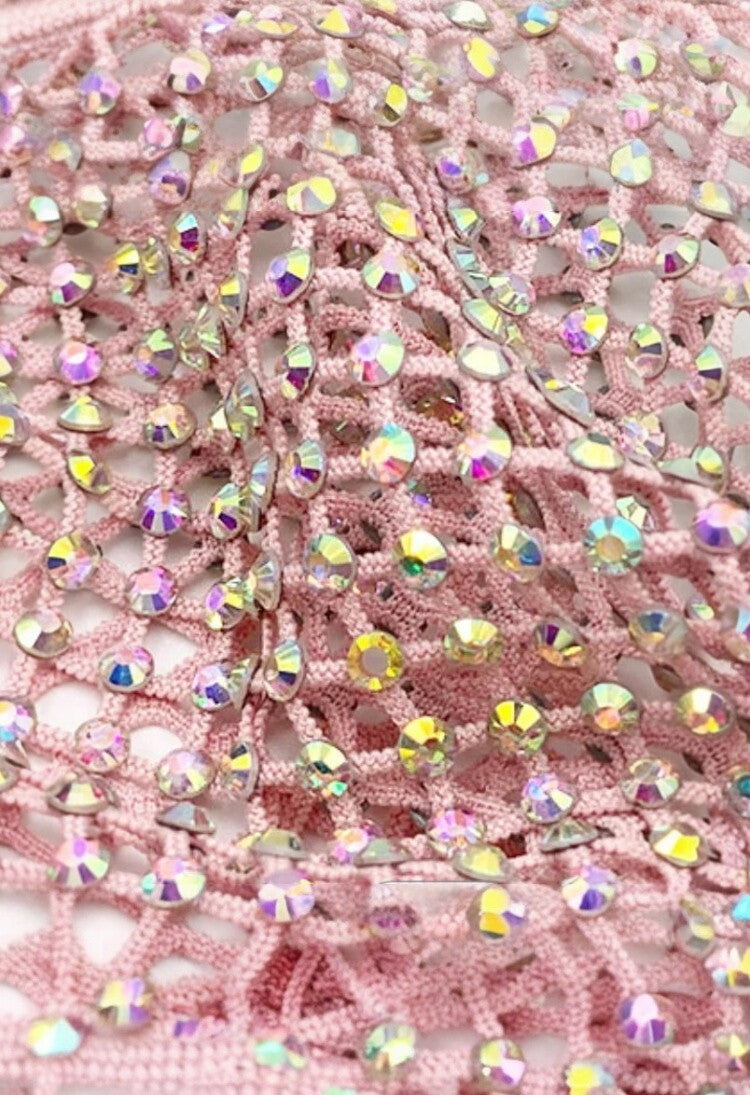 SlaySwimwear pink crochet mini skirt adorned with iridescent rhinestones and a rhinestone clasp closure.