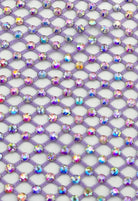 SlaySwimwear purple rhinestone mini skirt with clasp closure, featuring a fishnet design and all-over sparkle.