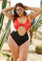 SlaySwimwear Queen Of Hearts red and black color block one-piece swimsuit with cut-outs and gold hardware.