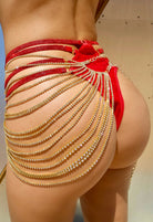 SlaySwimwear red velvet bikini bottom with gold rhinestone body chain and skirt. Versatile piece doubles as a chest piece.