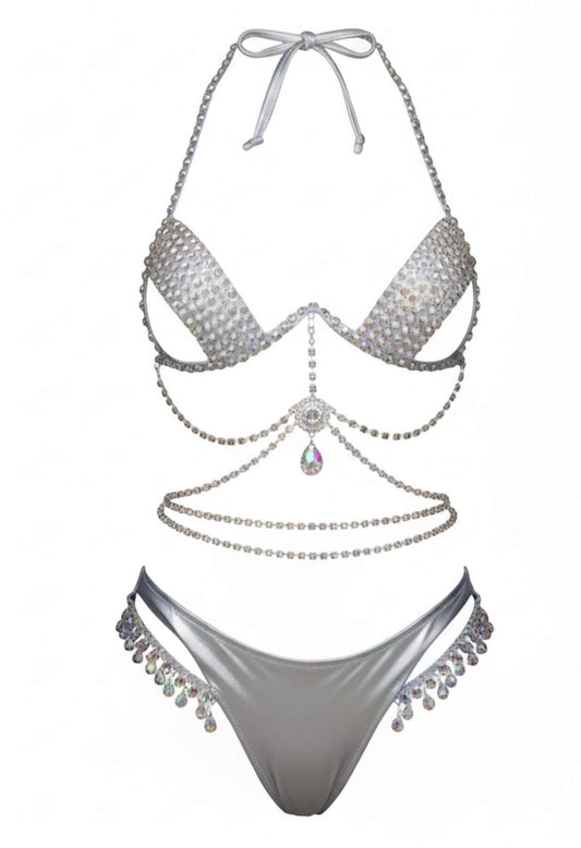 SlaySwimwear silver bikini set with rhinestone embellishments and crystal-style accents. Halter top and matching bottoms.