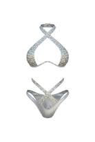 SlaySwimwear silver bikini set with sparkling rhinestone embellishments and criss-cross straps. Halter top and cheeky bottoms.
