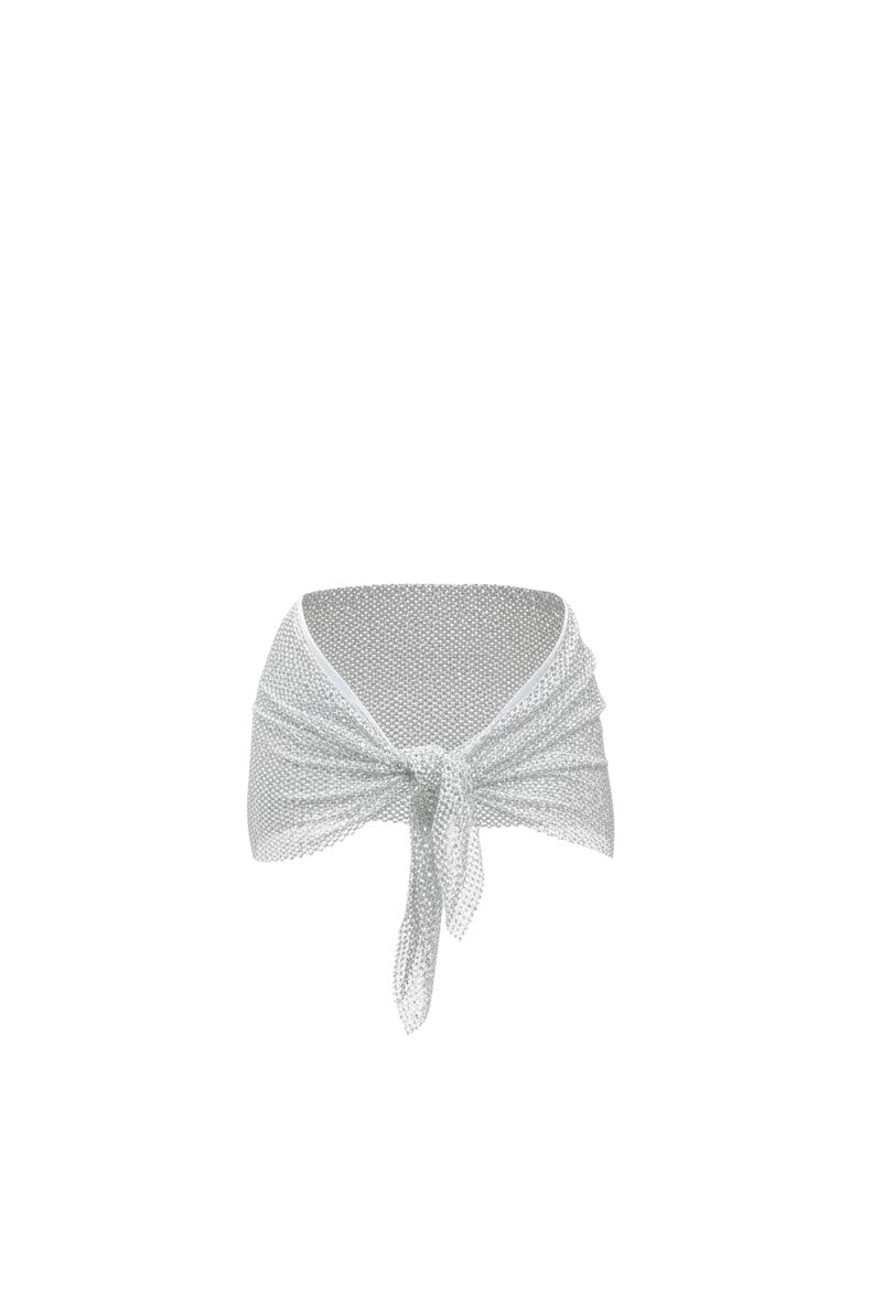 SlaySwimwear silver rhinestone tie-waist mini skirt with a mint green swimsuit underneath, styled by a model poolside.