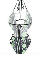 SlaySwimwear Snaky one-piece swimsuit with a plunging neckline, ladder straps, side cutouts, and a bold snakeskin print in neon green and black.