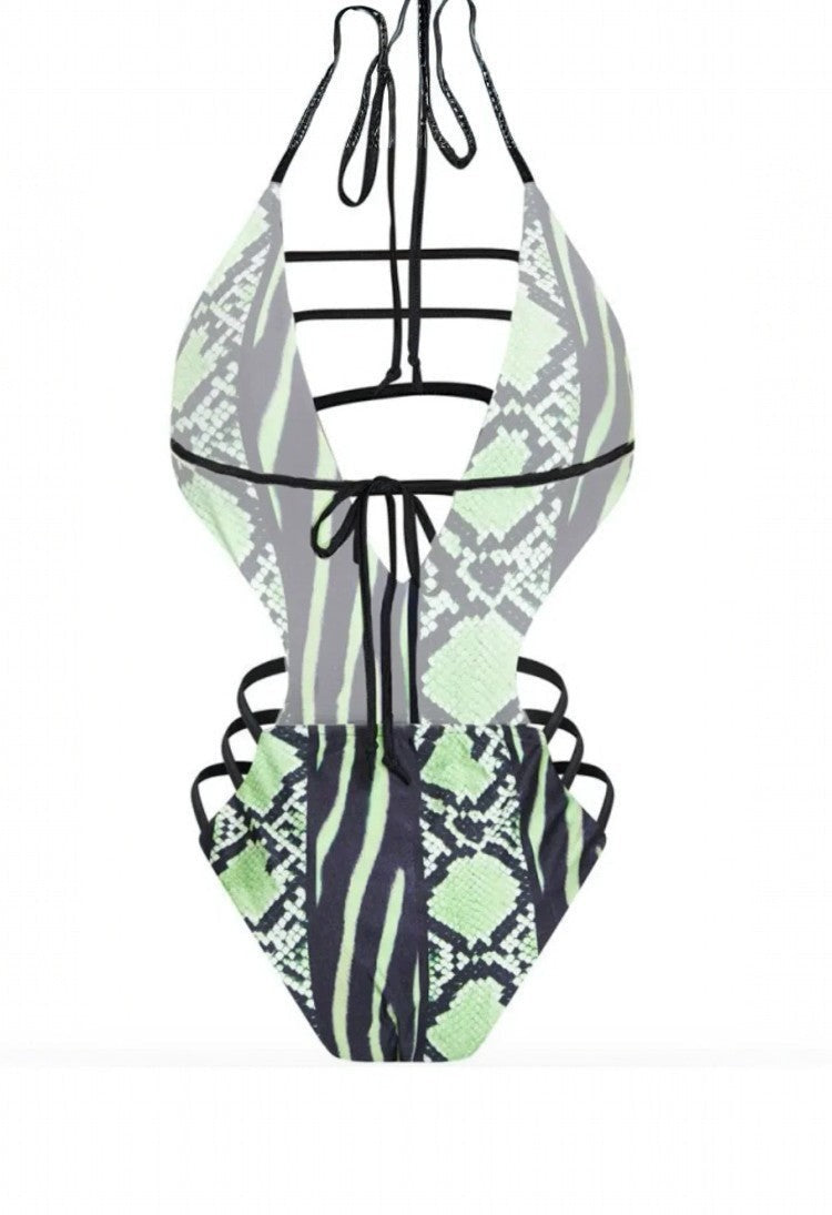 SlaySwimwear Snaky one-piece swimsuit with a plunging neckline, ladder straps, side cutouts, and a bold snakeskin print in neon green and black.