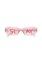SlaySwimwear Statement sunglasses with translucent pink rectangular frames and red "SLAY" text on lenses.