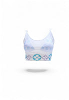 SlaySwimwear white sheer mesh crop top with rhinestone motif and matching bikini bottom and sarong skirt.