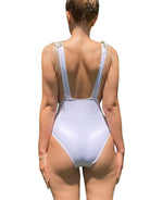 SlaySwimwear white one-piece swimsuit with rhinestone fringe shoulder detail and full coverage.