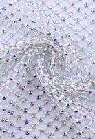 SlaySwimwear white rhinestone mini skirt with clasp closure, above-the-knee length, and all-over sparkle.