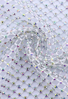 SlaySwimwear white rhinestone mini skirt with a net overlay and clasp closure, perfect for parties and events.