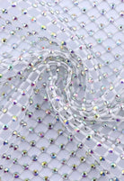 SlaySwimwear white rhinestone mini skirt with a net overlay and clasp closure, perfect for parties and events.