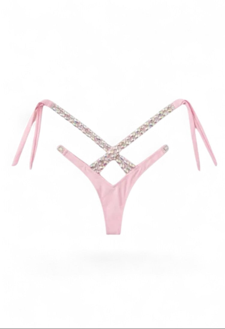 SlaySwimwearHere pink bikini with rhinestone criss-cross halter and V-front. High-cut legs, cheeky back.